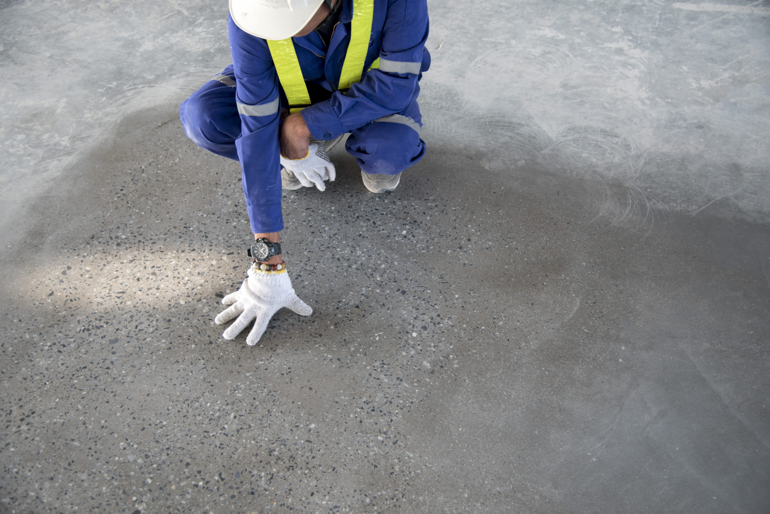 a construction worker check quality epoxy floor in warehouse factory japan construction site